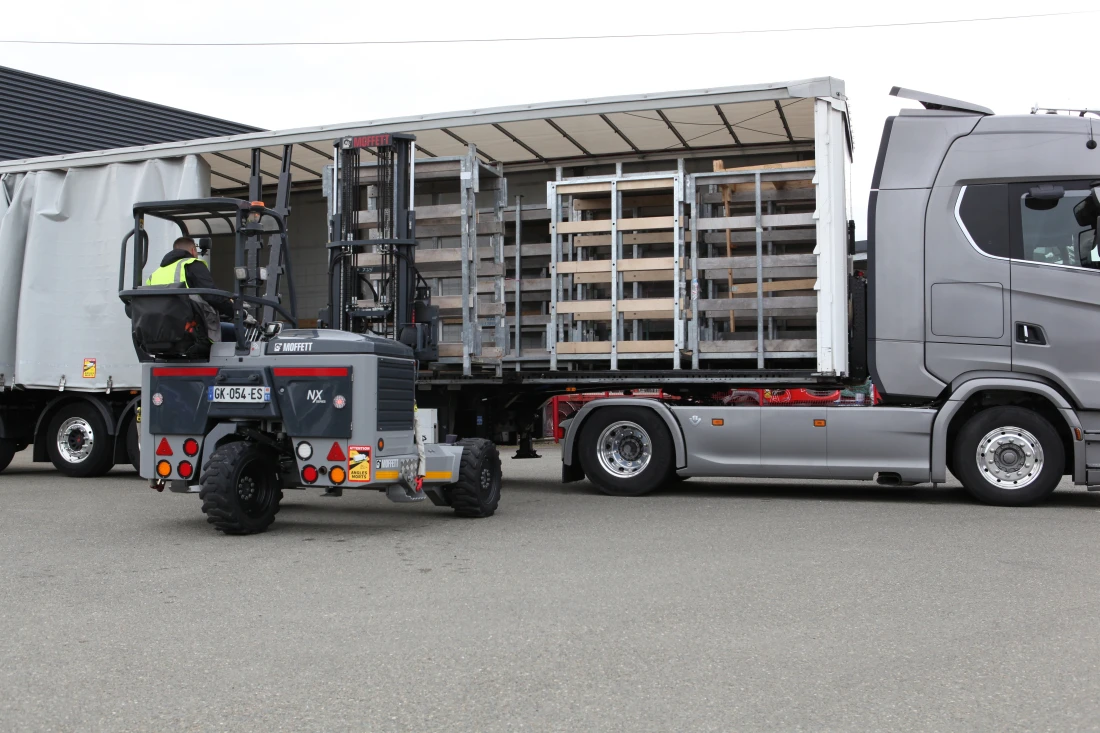 Camion avec un rideau lat&eacute;ral rempli de carton emball&eacute; sur des palettes